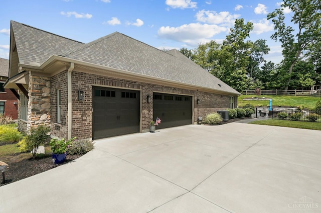 7574 Copper Creek Ln, Colerain Twp, OH 45247 - view of side of property with brick siding, a shingled roof, driveway, and an attached garage