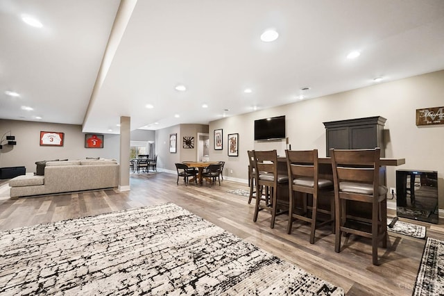 7574 Copper Creek Ln, Colerain Twp, OH 45247 - living area with wood finished floors, recessed lighting, and bar