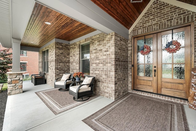 7574 Copper Creek Ln, Colerain Twp, OH 45247 - view of exterior entry featuring brick siding, a porch, and french doors