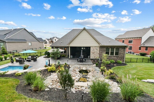 7574 Copper Creek Ln, Colerain Twp, OH 45247 - rear view of house featuring an outdoor living space with a fire pit, a patio, a fenced backyard, and a sunroom