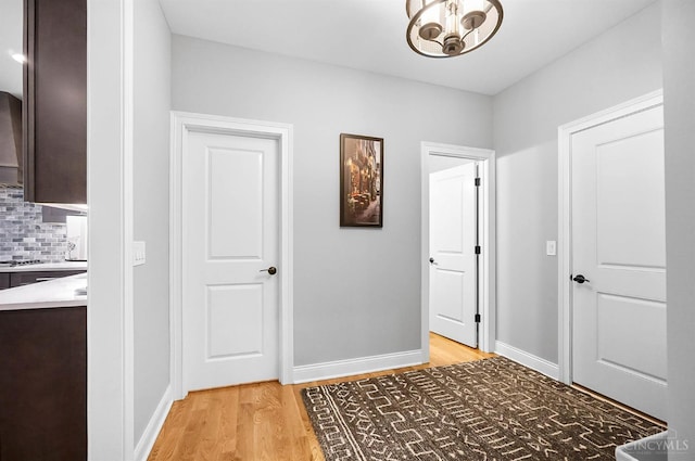 7574 Copper Creek Ln, Colerain Twp, OH 45247 - corridor with light wood-style flooring and a chandelier