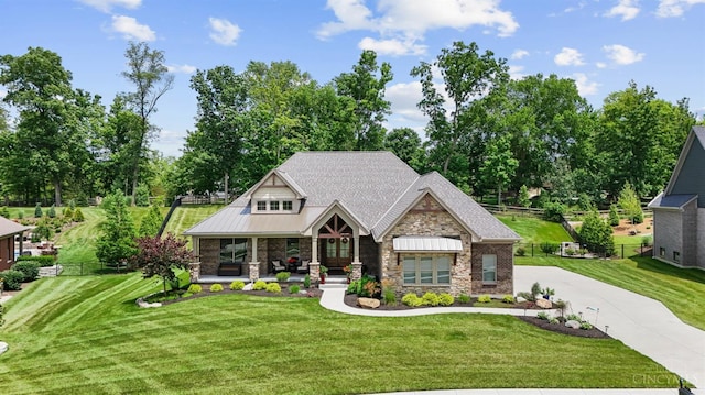 7574 Copper Creek Ln, Colerain Twp, OH 45247 - craftsman inspired home featuring stone siding, a porch, driveway, and view of scattered trees