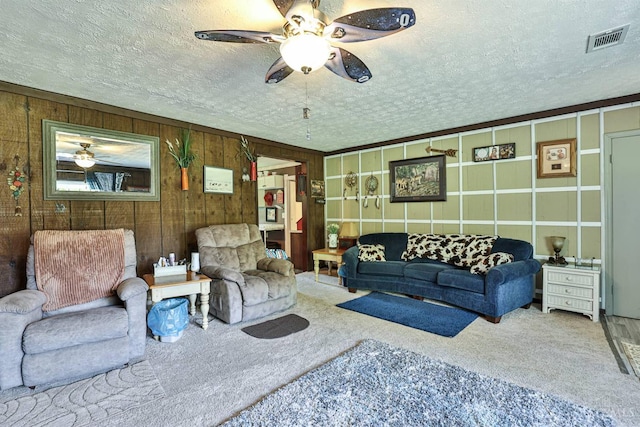1851 Parker Rd, Goshen Twp, OH 45150 - carpeted living area with ceiling fan, a textured ceiling, and wooden walls