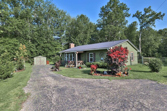 1851 Parker Rd, Goshen Twp, OH 45150 - view of front of property featuring a storage unit, a chimney, a metal roof, and driveway