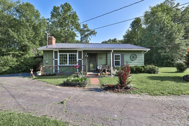 1851 Parker Rd, Goshen Twp, OH 45150 - view of front of property with covered porch, a chimney, a front yard, and a metal roof