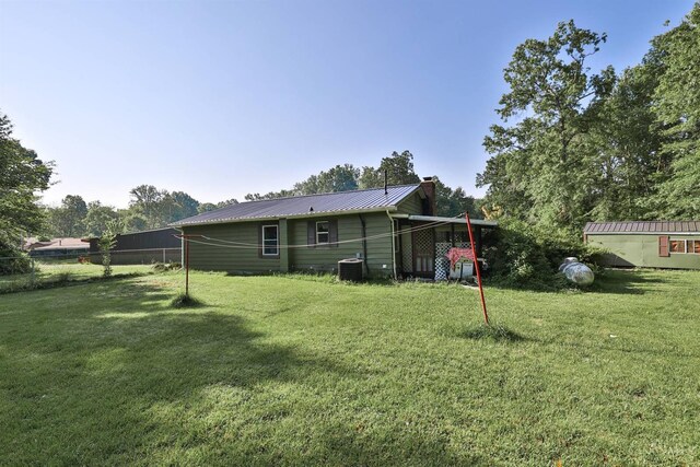 1851 Parker Rd, Goshen Twp, OH 45150 - rear view of property with a lawn, a metal roof, and a chimney