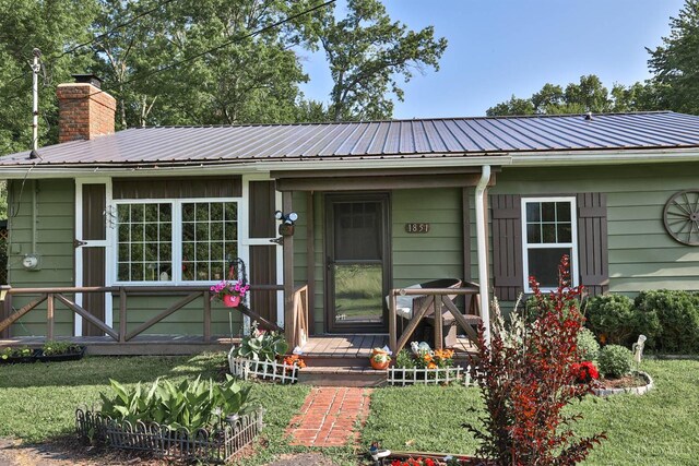 1851 Parker Rd, Goshen Twp, OH 45150 - view of front of house with a metal roof, a chimney, and a front yard