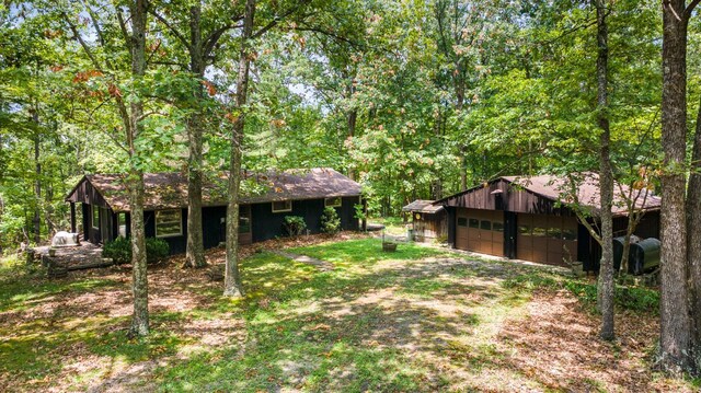 2765 Tater Ridge Rd, West Union, OH 45693 - view of yard featuring a detached garage, an outbuilding, and a forest view