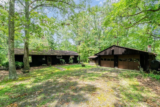 2765 Tater Ridge Rd, West Union, OH 45693 - view of yard featuring a garage, an outbuilding, and heating fuel