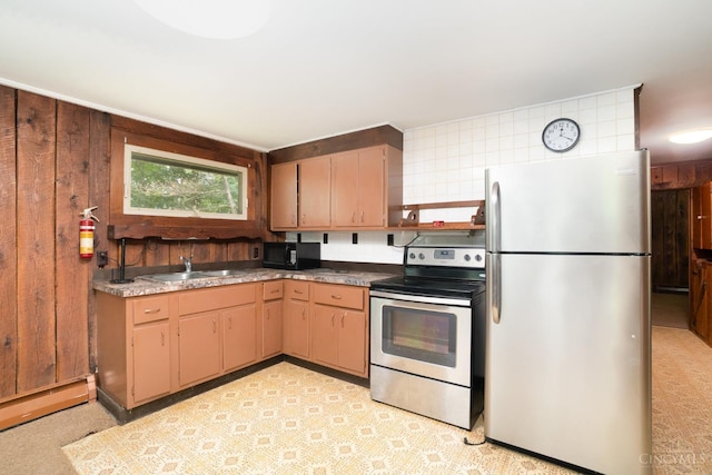 2765 Tater Ridge Rd, West Union, OH 45693 - kitchen with appliances with stainless steel finishes, baseboard heating, and wood walls