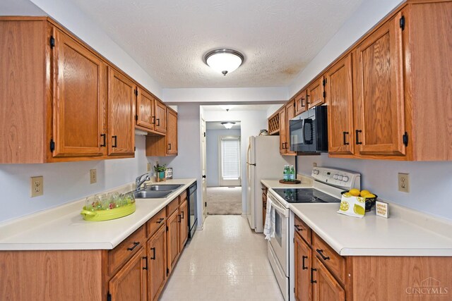 3016 Stratford Ct Unit 115, Cincinnati, OH 45140 - kitchen with black appliances, light countertops, brown cabinets, and a textured ceiling