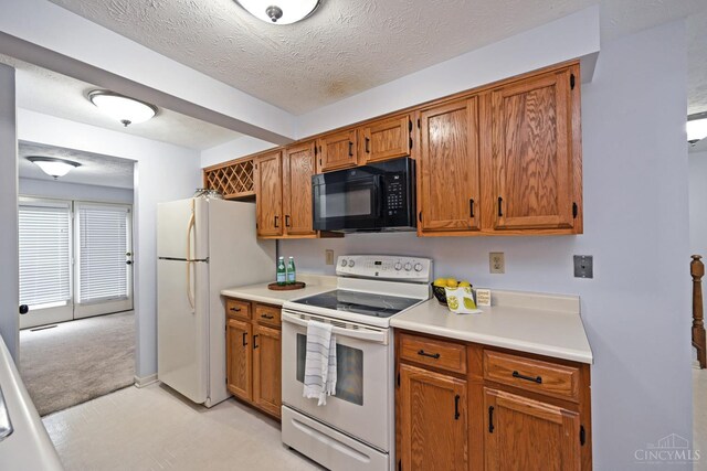 3016 Stratford Ct Unit 115, Cincinnati, OH 45140 - kitchen featuring white appliances, brown cabinetry, light countertops, and a textured ceiling
