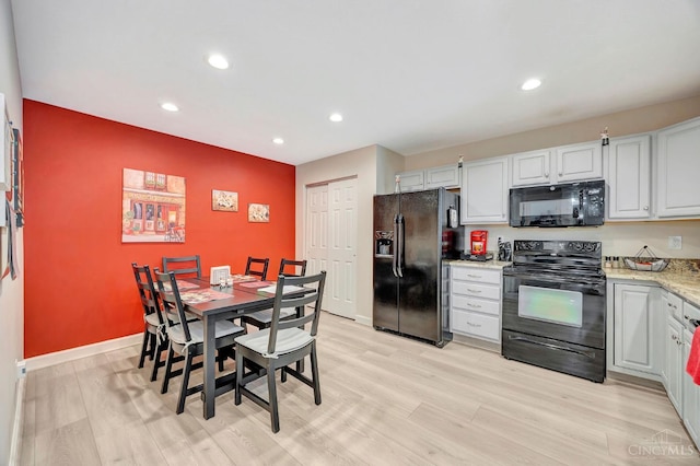 3435 Kleeman Lake Ct, Cincinnati, OH 45211 - kitchen featuring black appliances, recessed lighting, light wood-type flooring, and light stone countertops