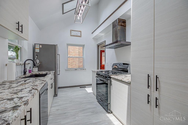 4213 Alex Ave, Cheviot, OH 45211 - kitchen featuring black appliances, wall chimney range hood, healthy amount of natural light, high vaulted ceiling, and white cabinetry