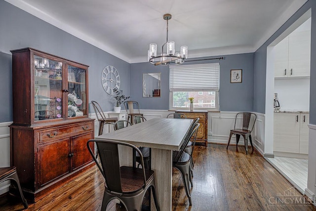 4213 Alex Ave, Cheviot, OH 45211 - dining space with a chandelier, dark wood finished floors, wainscoting, and a decorative wall
