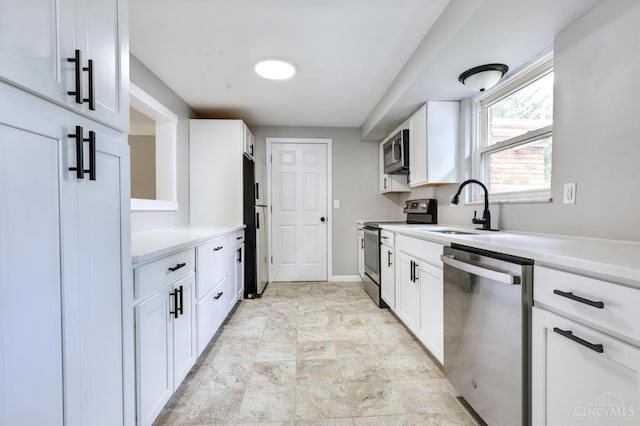 906 Shayler Rd, Union Twp, OH 45245 - kitchen featuring stainless steel appliances, light countertops, white cabinetry, and stone finish flooring