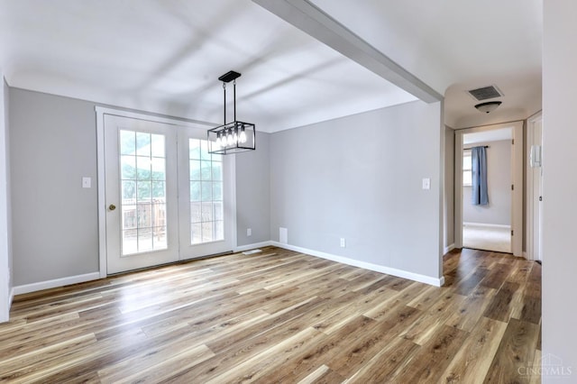 906 Shayler Rd, Union Twp, OH 45245 - unfurnished dining area with wood finished floors, healthy amount of natural light, and a chandelier