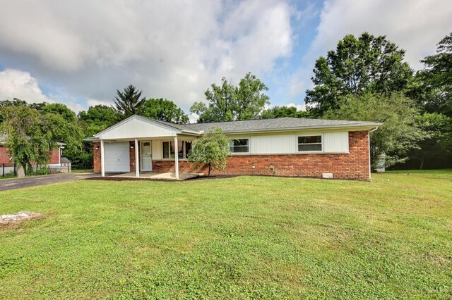 906 Shayler Rd, Union Twp, OH 45245 - single story home with a garage, brick siding, a front lawn, and asphalt driveway
