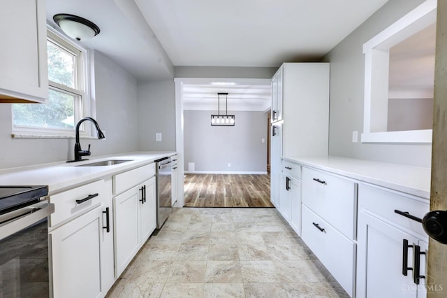 906 Shayler Rd, Union Twp, OH 45245 - kitchen with appliances with stainless steel finishes, light countertops, white cabinets, and hanging light fixtures