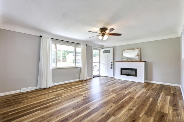 906 Shayler Rd, Union Twp, OH 45245 - unfurnished living room featuring ceiling fan, a glass covered fireplace, and wood finished floors