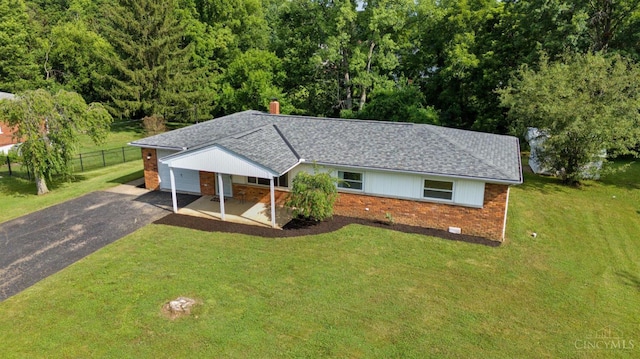 906 Shayler Rd, Union Twp, OH 45245 - single story home featuring brick siding, asphalt driveway, a chimney, roof with shingles, and a wooded view