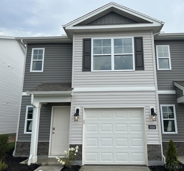 3358 New Year Dr, Colerain Twp, OH 45251 - view of front of house with stone siding, a garage, and concrete driveway