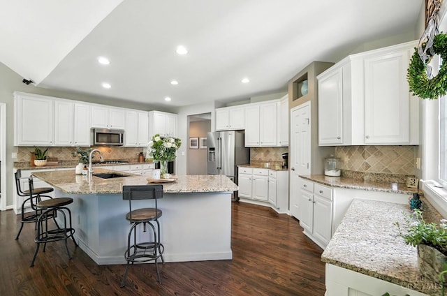 4048 Frye Park Cir, Mason, OH 45040 - kitchen with appliances with stainless steel finishes, decorative backsplash, dark wood-style flooring, white cabinetry, and recessed lighting