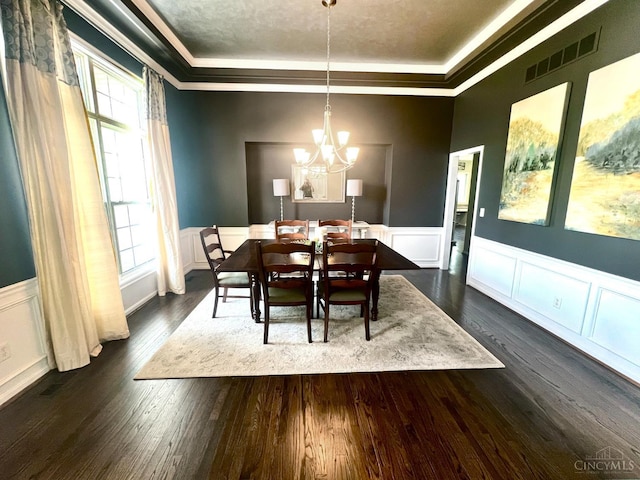 4048 Frye Park Cir, Mason, OH 45040 - dining space featuring a tray ceiling, ornamental molding, a chandelier, a decorative wall, and dark wood-style floors