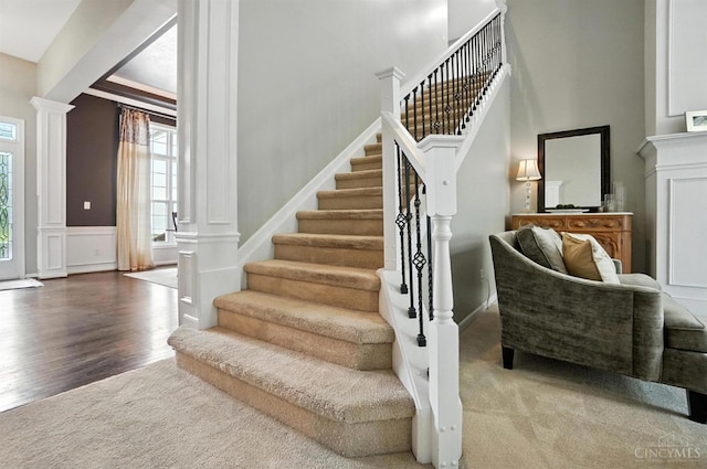 4048 Frye Park Cir, Mason, OH 45040 - staircase featuring ornate columns, wood finished floors, a decorative wall, and wainscoting