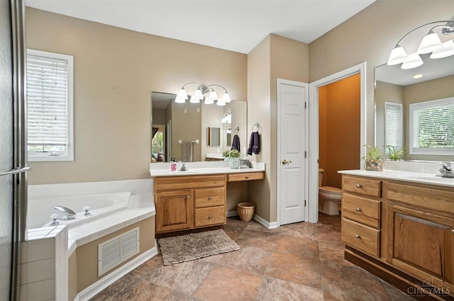 4048 Frye Park Cir, Mason, OH 45040 - bathroom with two vanities, a garden tub, and stone finish flooring