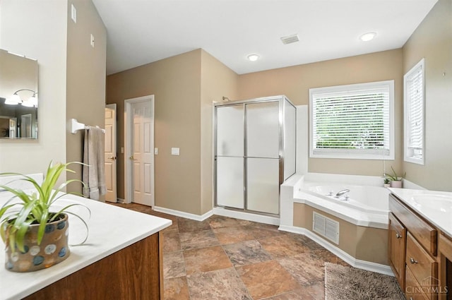 4048 Frye Park Cir, Mason, OH 45040 - full bathroom with vanity, a stall shower, a garden tub, and stone finish floors