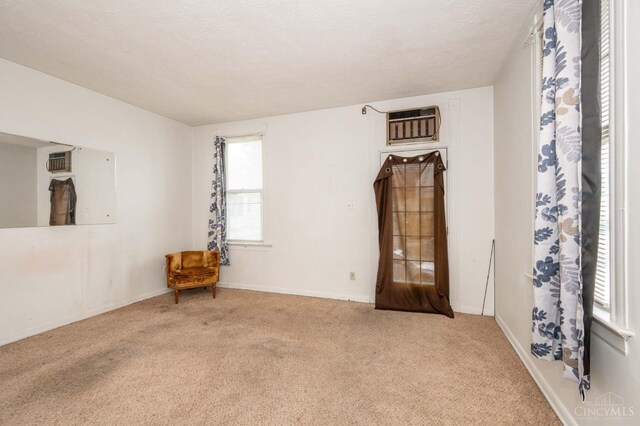 5653 Prosser Ave, Elmwood Place, OH 45216 - carpeted empty room featuring an AC wall unit and baseboards