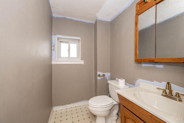 5653 Prosser Ave, Elmwood Place, OH 45216 - half bathroom with tile patterned floors, vanity, and a textured ceiling