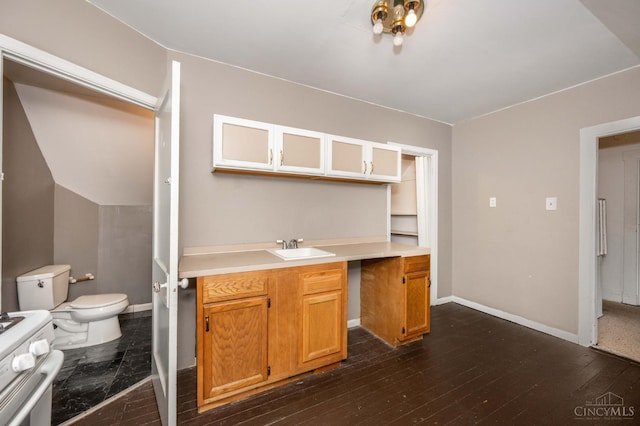 5653 Prosser Ave, Elmwood Place, OH 45216 - kitchen with white gas range, light countertops, dark wood-style flooring, and glass insert cabinets