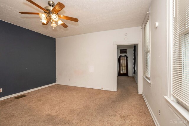 5653 Prosser Ave, Elmwood Place, OH 45216 - spare room featuring ceiling fan, a textured ceiling, and light carpet