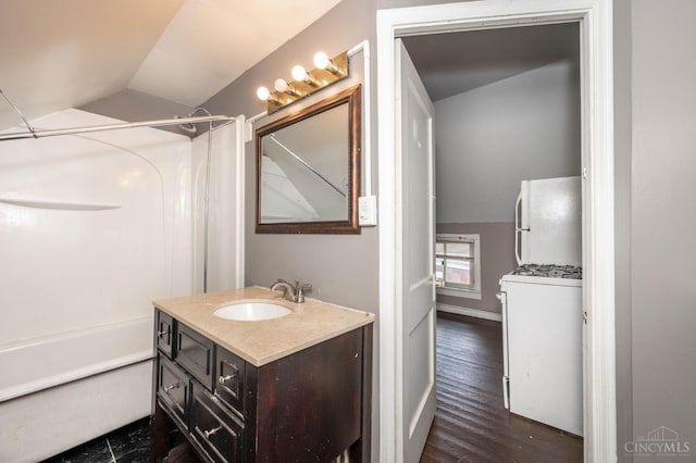 5653 Prosser Ave, Elmwood Place, OH 45216 - bathroom featuring vaulted ceiling, vanity, shower / bath combination, and wood finished floors