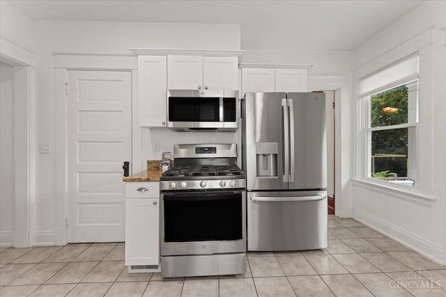 3131 Troy Ave, Cincinnati, OH 45213 - kitchen with stainless steel appliances, light tile patterned floors, white cabinets, and dark stone counters