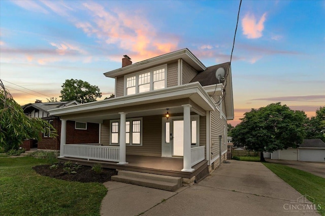 3131 Troy Ave, Cincinnati, OH 45213 - view of front of house featuring a chimney, a porch, and a yard