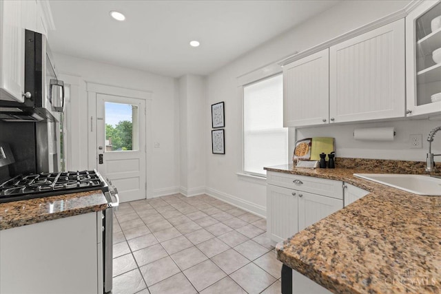 3131 Troy Ave, Cincinnati, OH 45213 - kitchen with stainless steel appliances, white cabinets, light tile patterned floors, glass insert cabinets, and recessed lighting