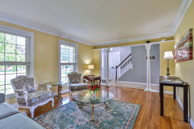 5681 Thomaridge Ct, Green Twp, OH 45248 - living area featuring decorative columns, healthy amount of natural light, crown molding, wood finished floors, and stairs