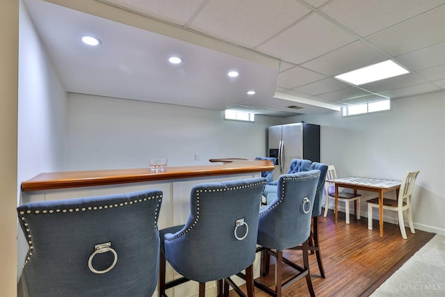 5681 Thomaridge Ct, Green Twp, OH 45248 - bar with stainless steel refrigerator with ice dispenser, recessed lighting, wood finished floors, and a paneled ceiling