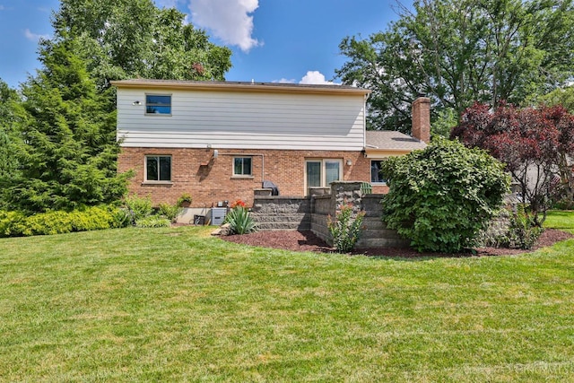 5681 Thomaridge Ct, Green Twp, OH 45248 - rear view of house with brick siding, a yard, and a chimney