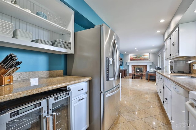 5681 Thomaridge Ct, Green Twp, OH 45248 - kitchen featuring beverage cooler, stainless steel refrigerator with ice dispenser, a brick fireplace, white cabinets, and recessed lighting