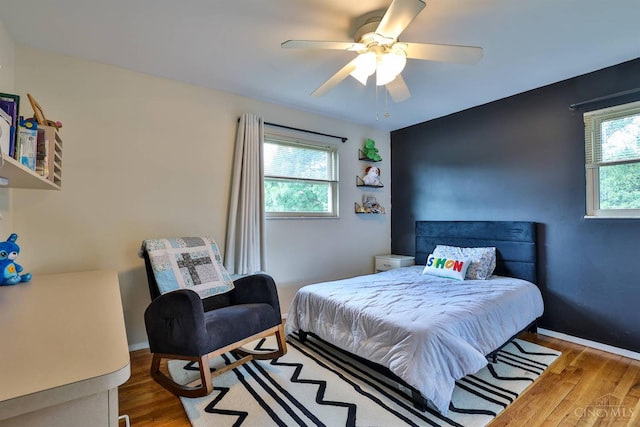 5681 Thomaridge Ct, Green Twp, OH 45248 - bedroom with multiple windows, wood finished floors, and ceiling fan