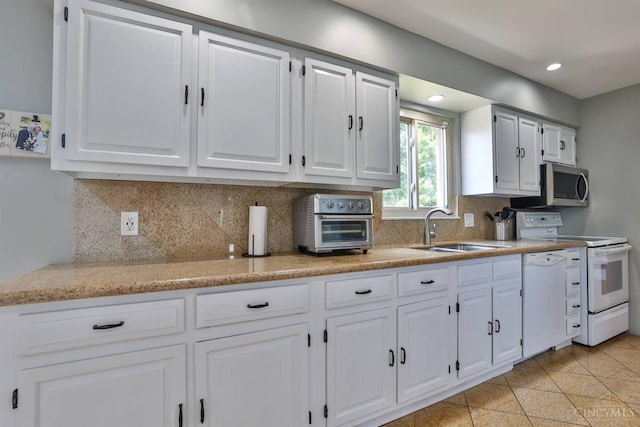 5681 Thomaridge Ct, Green Twp, OH 45248 - kitchen with white appliances, white cabinets, decorative backsplash, recessed lighting, and granite tiled floors