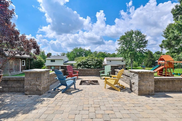 5681 Thomaridge Ct, Green Twp, OH 45248 - view of patio featuring a fire pit, a playground, and an outdoor structure
