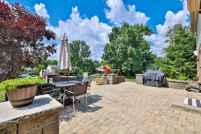 5681 Thomaridge Ct, Green Twp, OH 45248 - view of patio / terrace with a playground, outdoor dining space, and area for grilling