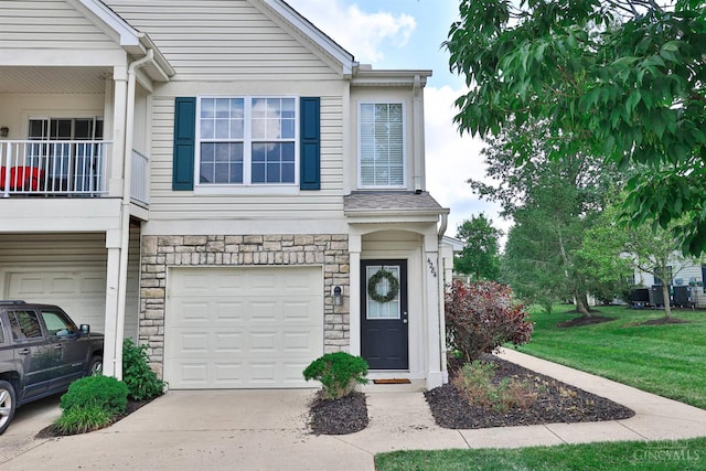 4282 Hickory Park Ln, Batavia Twp, OH 45103 - view of front facade with an attached garage, stone siding, driveway, and a front yard