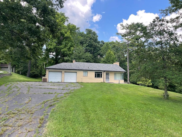 6172 Werk Rd, Green Twp, OH 45248 - ranch-style home with a chimney, asphalt driveway, an attached garage, and a front lawn