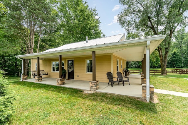 3008 State Route 133, Bethel, OH 45106 - rear view of property featuring a yard, a metal roof, and a patio area